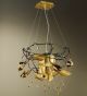 Spirale design forged metal chandelier with blown coloured glass details